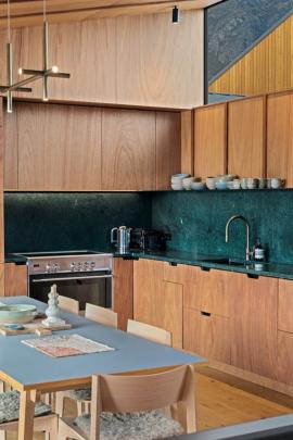 Plywood joinery is paired with a Verde Guatemala marble bench top and splashback. The kitchen was...