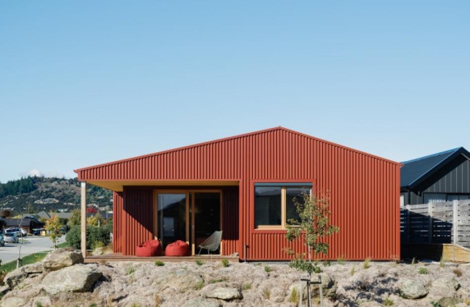 With its red corrugated iron cladding, the house is reminiscent of a mountain hut. The bank was...