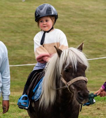 Elderflower Maguire, 3, of Palmerston, rides a pony for the first time at the Palmerston A&P Show.