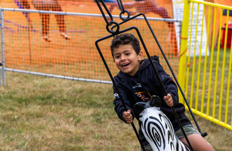 Charlie Downes, 6, of Palmerston, rides the spinning zebras.