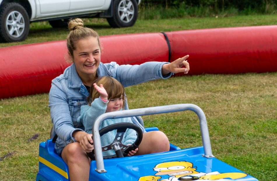 Stacey and Sienna, 2,  Pennell ride the mini jeeps. PHOTOS: WYATT RYDER