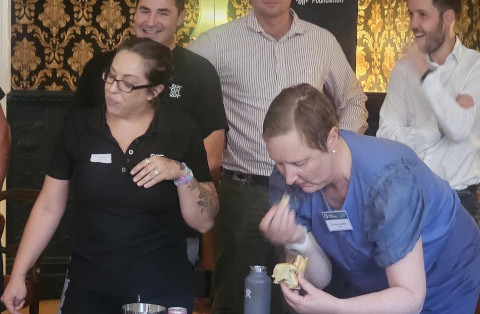 Getting stuck into their pies are Olivia Rawson (left) and Aoraki Foundation board member...