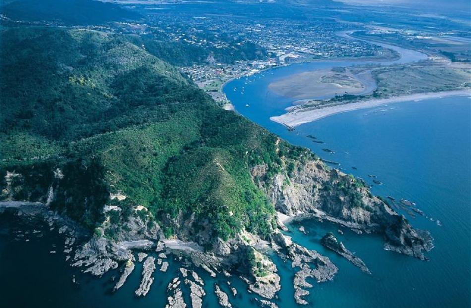 Kohi Point and the Whakatane Heads. Jagged fingers of rock reach out from the tranquil Whakatane...