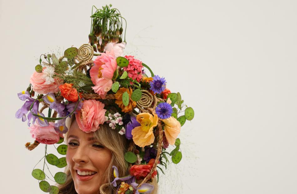 A model wears floral-themed headwear at the Chelsea Flower Show, in London.