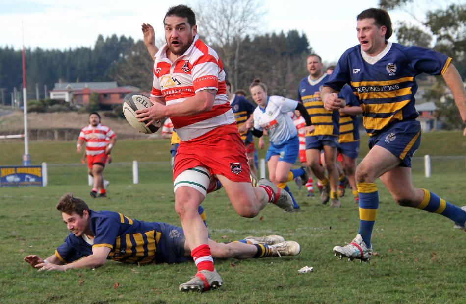 Tyler Bichan takes in the surroundings as he breaks away from Jared Hayes (ground) and Damon...