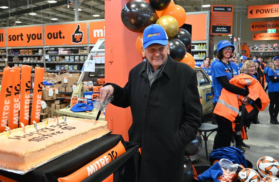 Neville Dippie cuts a birthday cake celebrating Mitre 10's 50th birthday.