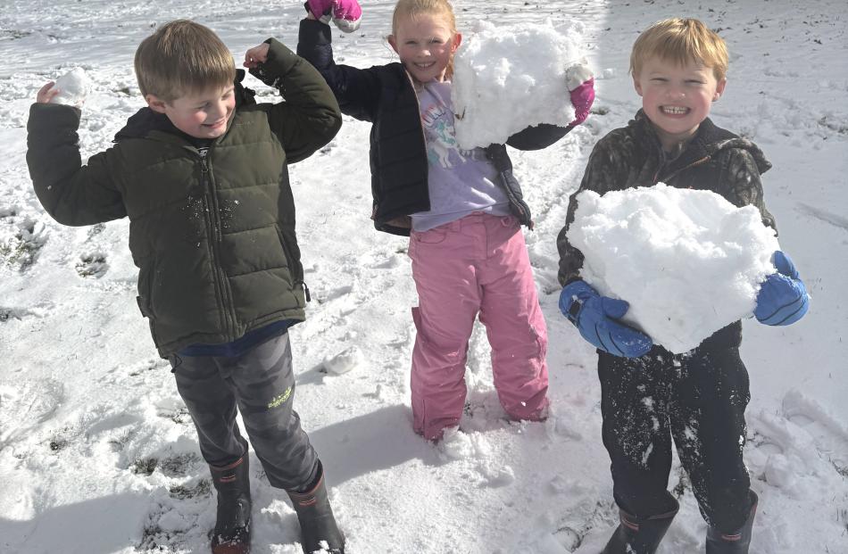 Gus Nichol (6) Florence Harris (7) Jack Richards (6) enjoy the snow at Lee Stream School. Photo:...