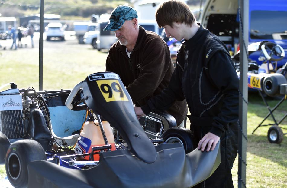 Keryn and Stefan, 15, Maynard, of Invercargill, work on fixing Stefan's kart before their next...