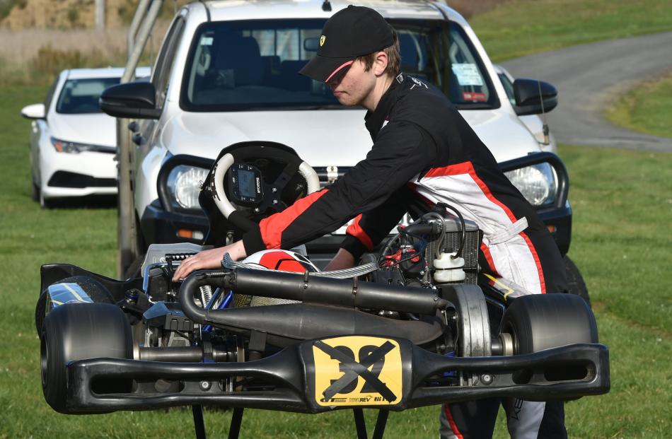 Jonathan Copley, of Mosgiel, works on his 125cc, Rotax powered kart.