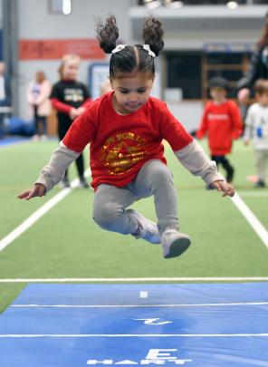 Nita Hakavalu, 3, goes for gold in the long jump. 