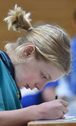 East Taieri School pupil Arnelle Hamman, 10, focuses on finishing a maths problem.