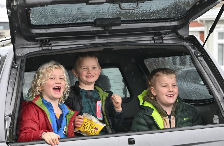 Watching the convoy from the shelter of their dad’s ute in Victoria Rd are brothers (from left)...