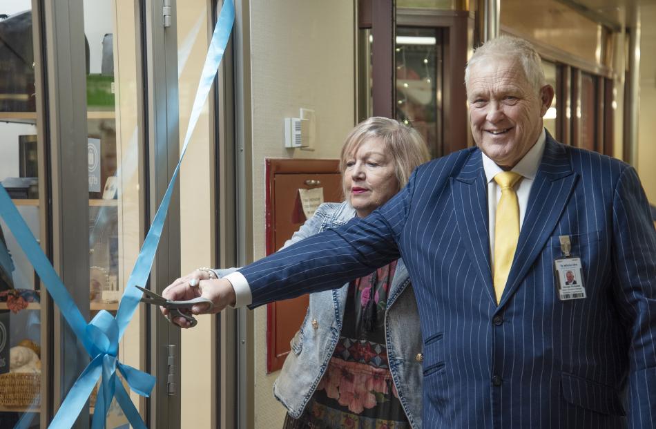 Hospital senior operations manager George Schwass cutting the ribbon to reopen the gift shop with...