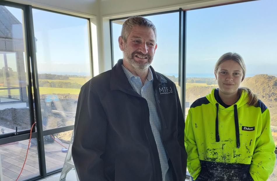  Kaikōura Mayor Craig Mackle (left) checks in on apprentice painter Amber Jellyman (18). Photo:...