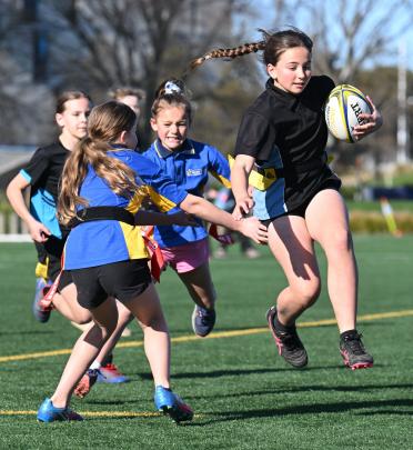 Valerie Beatson, 11, of Anderson’s Bay School, tries to beat the Strath Taieri defence. PHOTOS:...