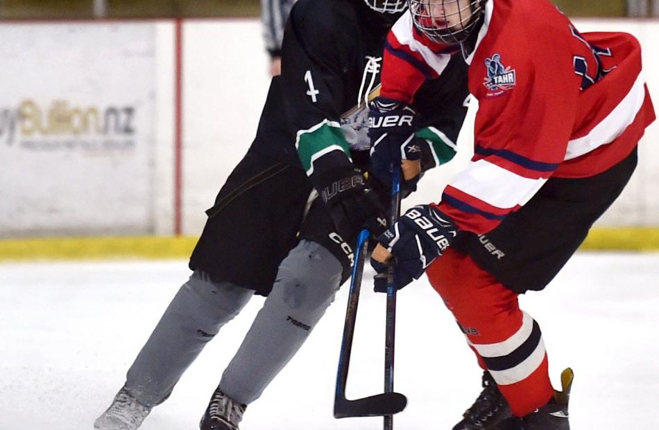 Burnside High School ice hockey player Jack Barton (left) battles Sef Johnston, an Otago Boys’...