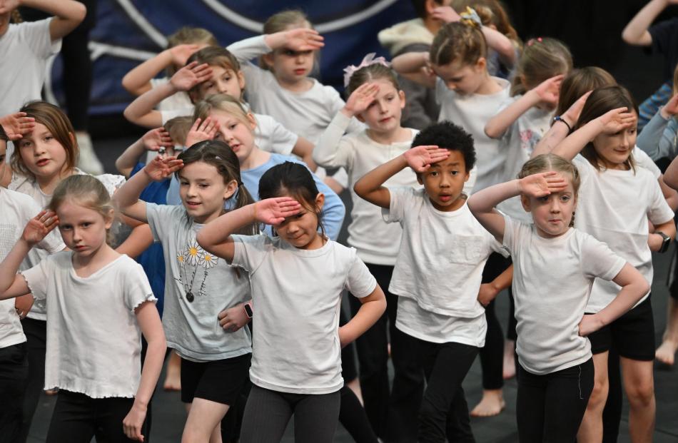 Pupils from St Clair School salute in unison.