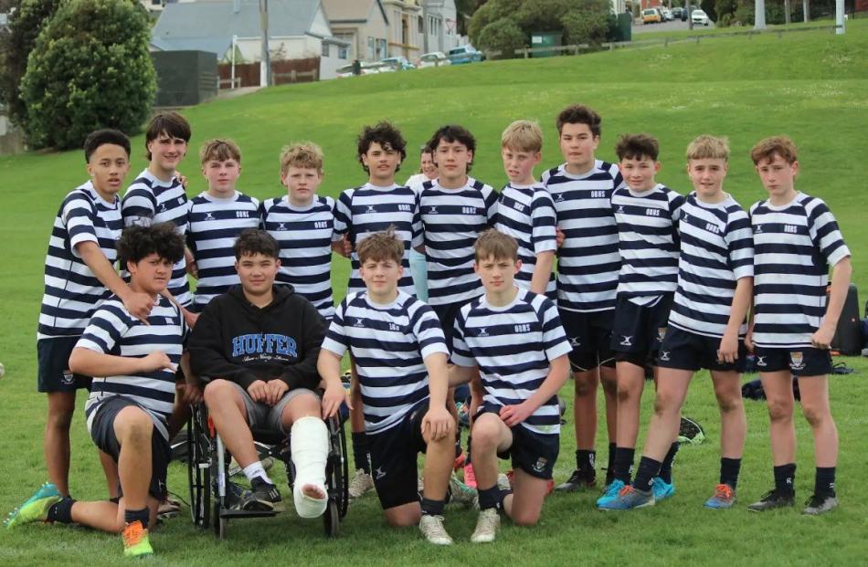 Otago Boys’ under-14 rugby league players support one of their injured warriors.