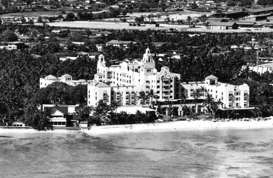 This 1947 photo shows the coastline at Waikiki Beach with the Royal Hawaiian Hotel prominent in...