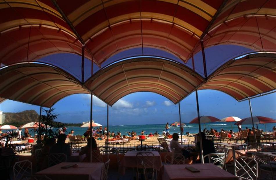 The colourful awnings add shade to the Mai Tai Bar at the Royal Hawaiian Hotel. Photo by Lucy...