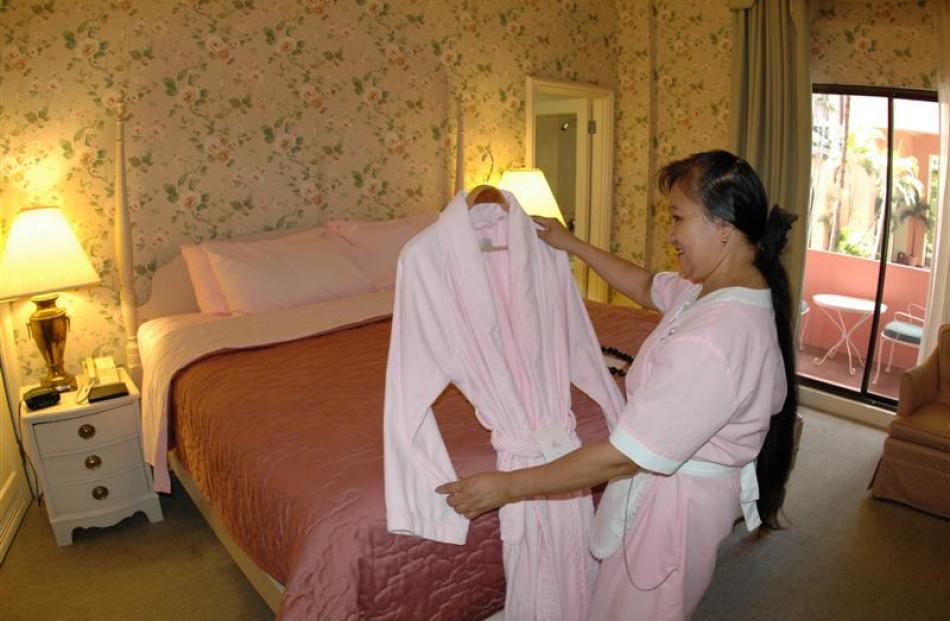 Loreta Gaeusan prepares a robe for guests staying at the hotel. The new look interior will lack...