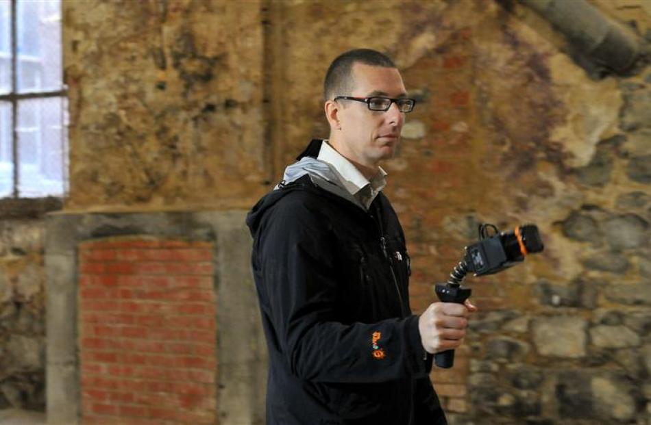 Iain Bramwell, from 3-D Laser Mapping in Perth, measures the athenaeum building in Dunedin with a...