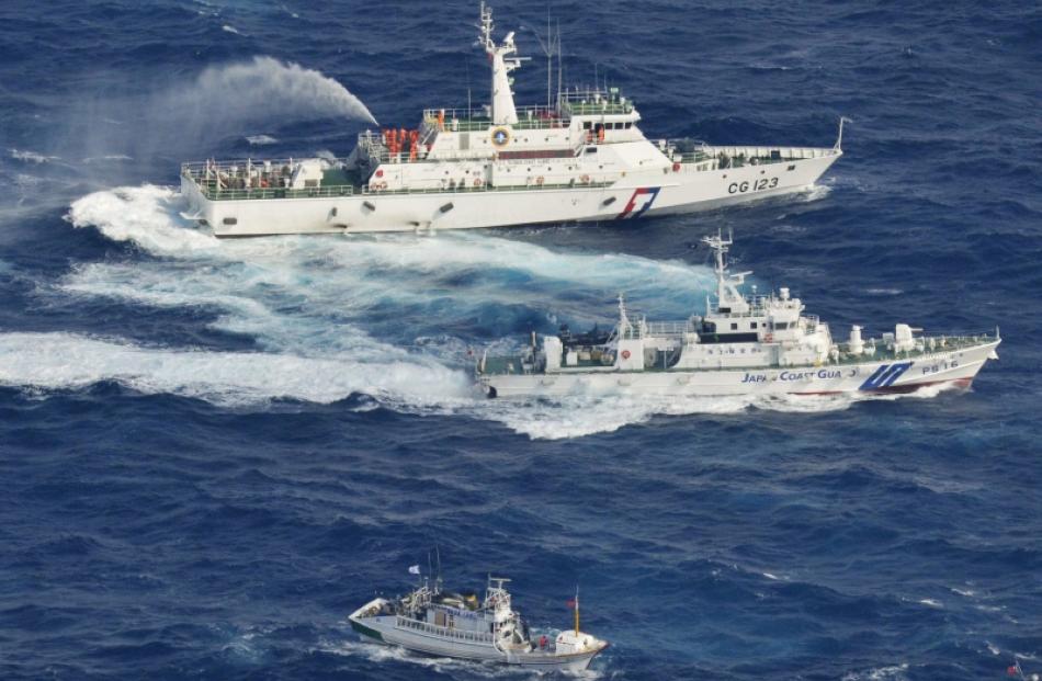 An aerial view shows Japan Coast Guard patrol ship (centre) and Taiwan's Coast Guard vessel (top)...