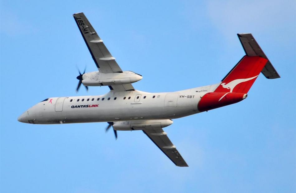 An Eastern Australian Airlines Bombardier Q300  flies on a QantasLink service in Australia. Photo...