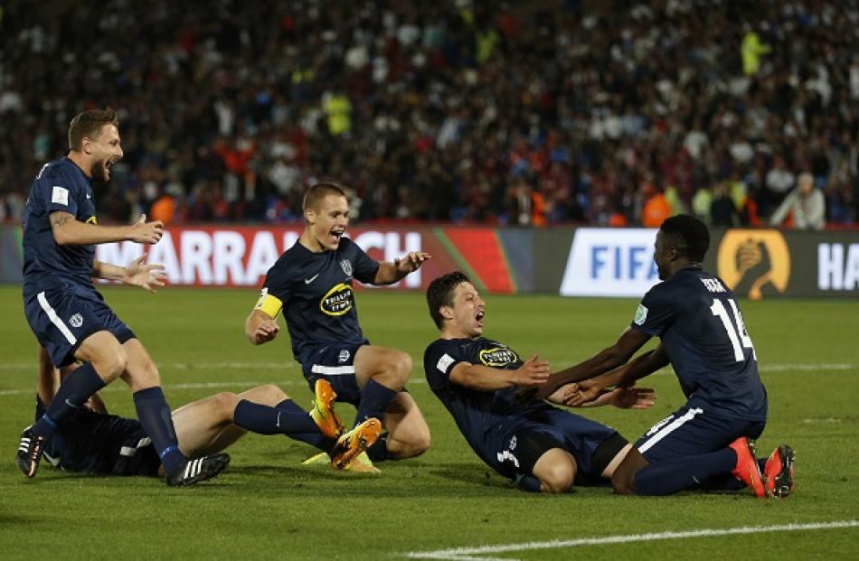 Auckland City FC players celebrate after their victory in a penalty shoot out against Cruz Azul...