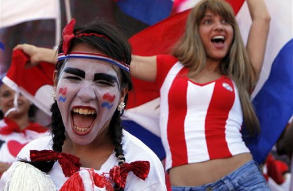 Fans celebrate Paraguay making it to the next round of the South Africa 2010 WCup, after a match...