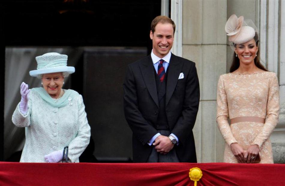 Britain's Queen Elizabeth waves next to Prince William and Catherine, Duchess of Cambridge, on...