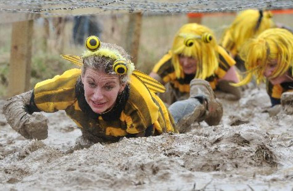 Bumblebee Alex Hannagan grits her teeth and pushes through the barbed wire challenge.