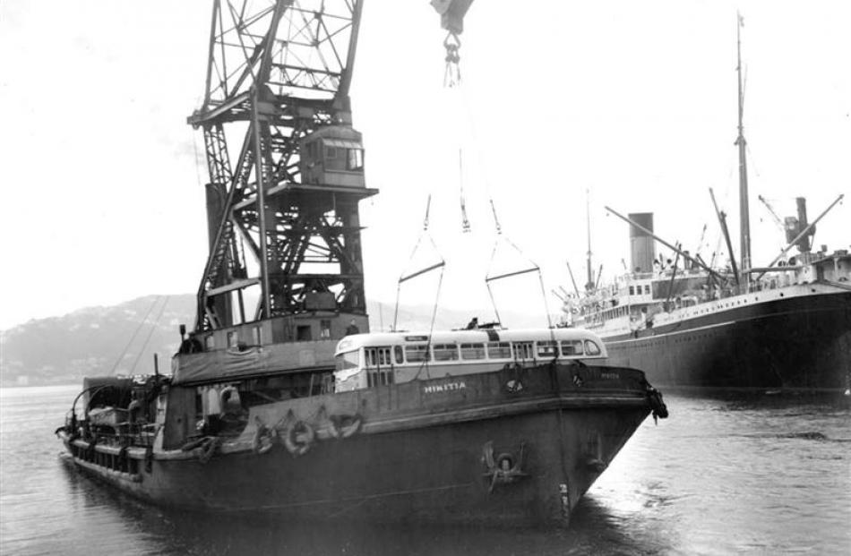 Dunedin's first trolley bus, DCT No 1, is loaded by crane on to a ship bound for Dunedin in 1950,...
