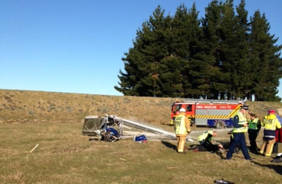 Emergency services staff inspect the scene of the crash.