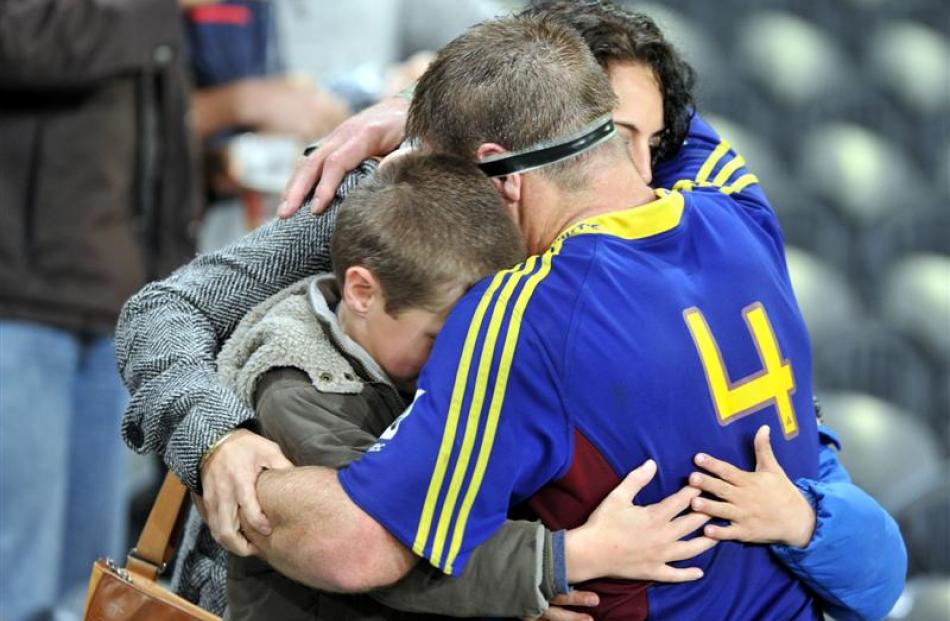 Highlanders lock Brad Thorn is swamped by hugs from wife Mary-Ann and sons Brendan (9) and Aiden ...