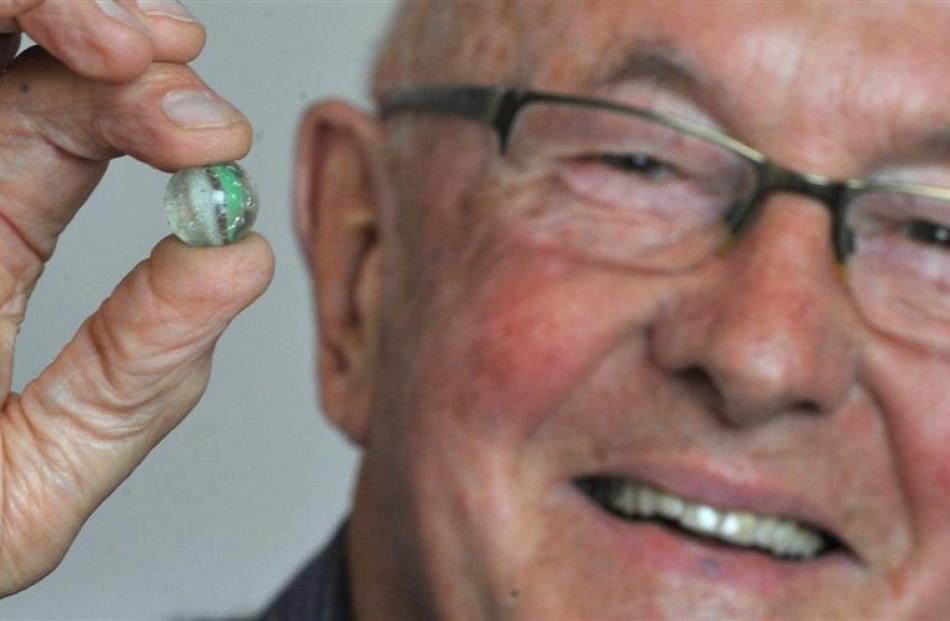 John Verboeket with his prized marble, which he recently retrieved having buried it under a house...