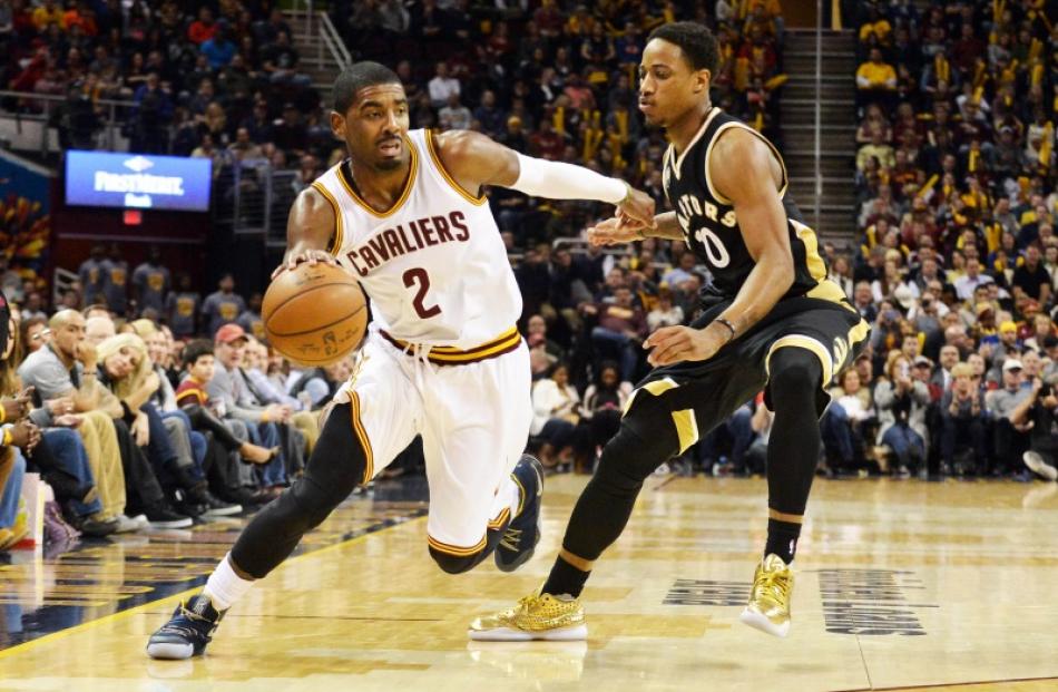 Kyrie Irving dribbles past DeMar DeRozan in the Cavs win over the Raptors. Photo: Reuters