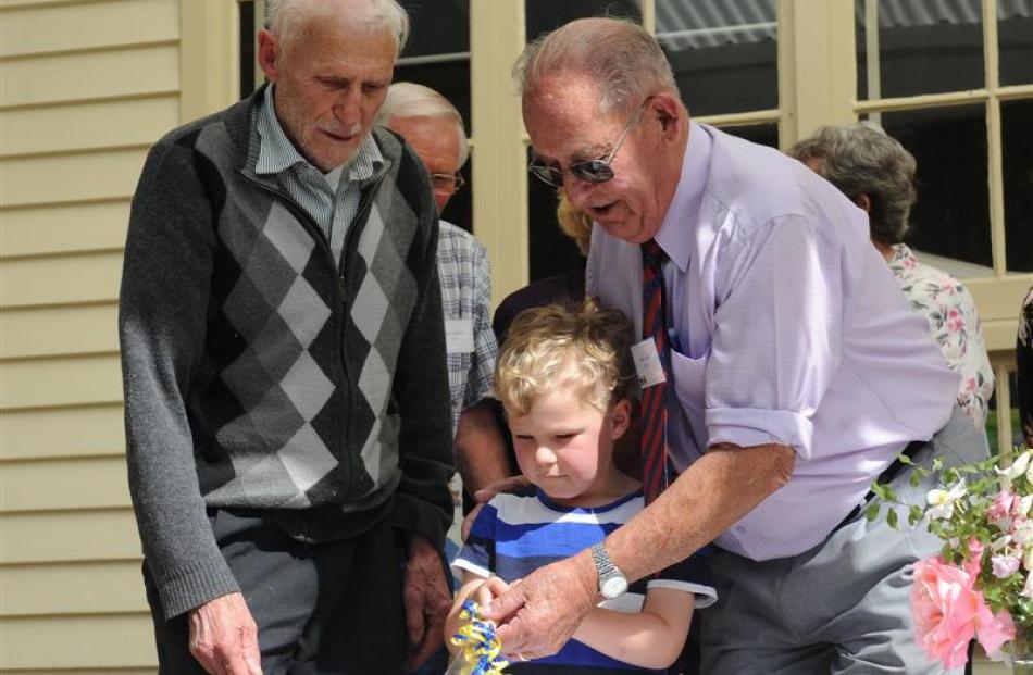 Opoho School, Dunedin, first-day pupils (from left) Roy Quennell (82) and Allan Smith (82) help...