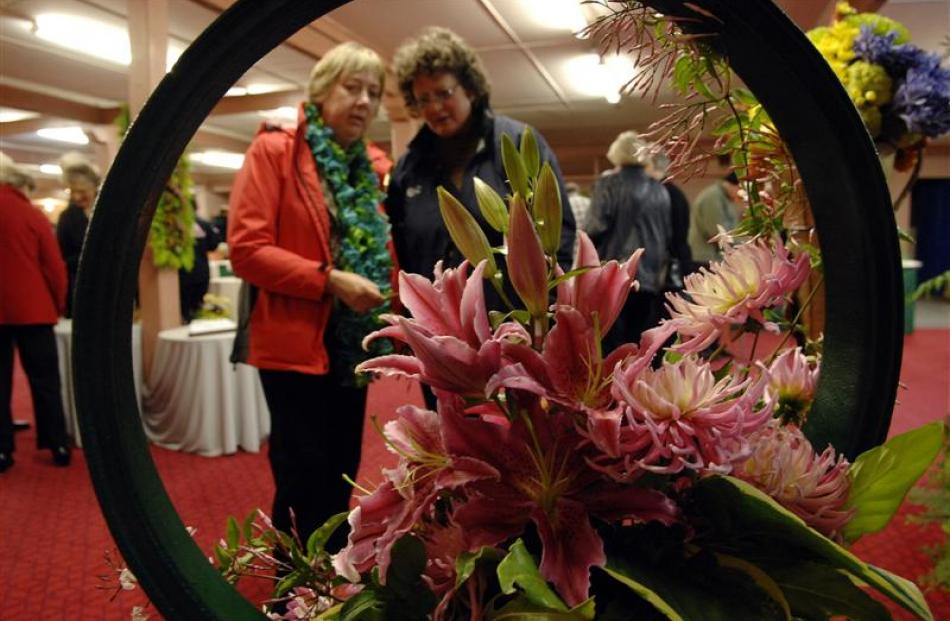 Otago Lily Society members Anne Corrigall (left) and Karen Judge admire the "free standing floral...