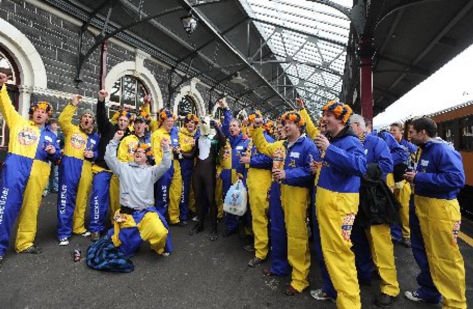 Otago supporters celebrate at Dunedin Railway Station before boarding the train to the Ranfurly...