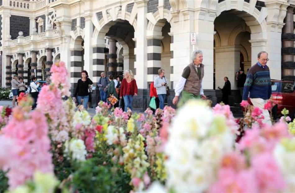 Pedestrians walk to work from the Dunedin Railway Station after catching a train that ran from...