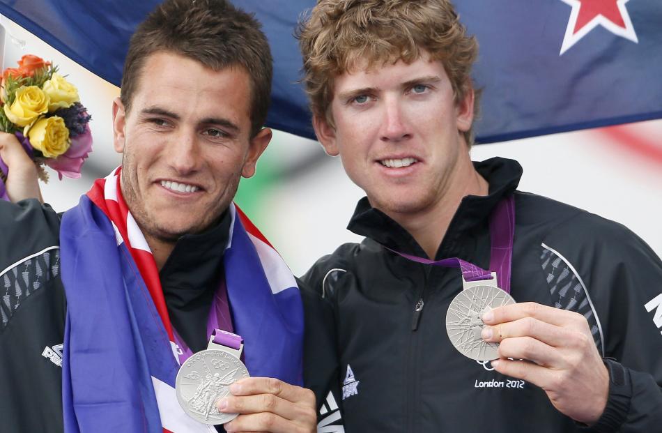 Peter Burling and Blair Tuke celebrate winning New Zealand's 100th medal, silver in the men's...