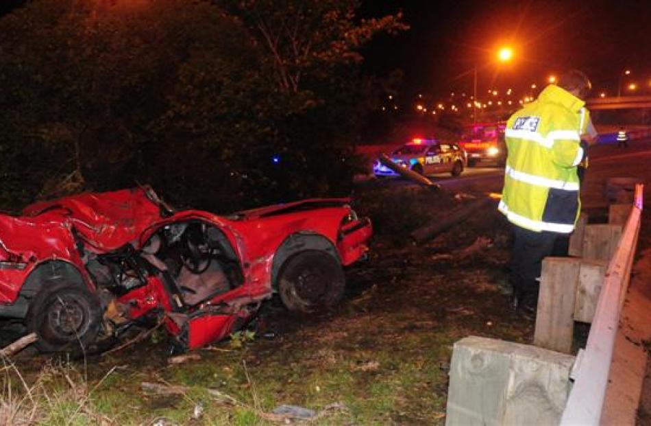 Police attend a serious accident on the Southern Motorway near Green Island on Saturday night....