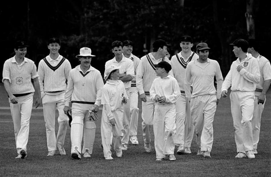 Schoolboys Brendon (left) and Nathan McCullum lead their Albion senior club team-mates off the...