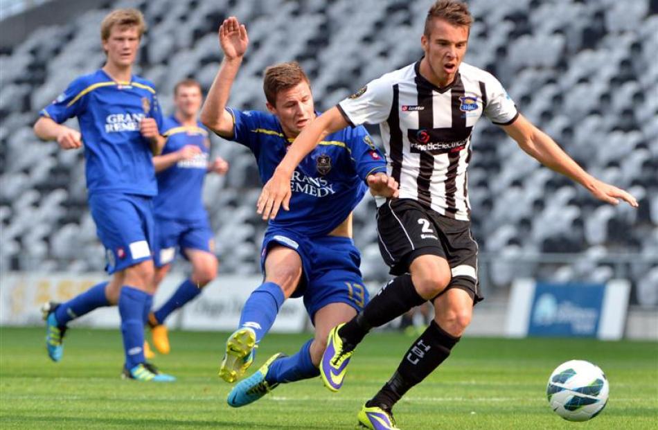 Southern United's  Logan Wrightwebb  challenges Aaron Jones (Hawkes Bay) during their ASB...