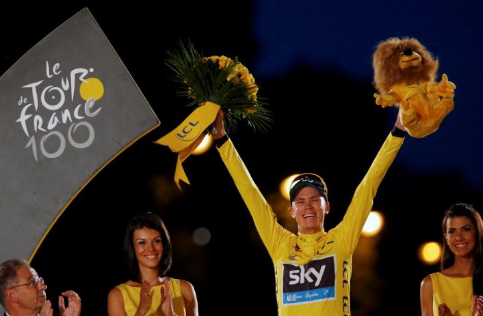 Team Sky rider Chris Froome of Britain celebrates his Tour de France victory on the podium after...