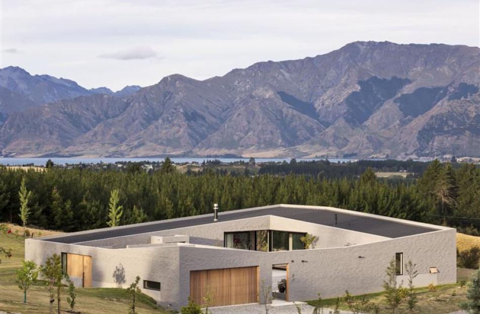 The roofline echoes the mountains around, while the low profile house is bunkered into its...