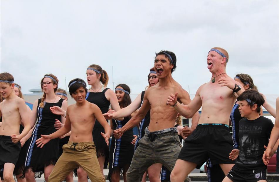 Tutor Hohepa Raharuhi (centre) leads the Catlins Area School kapa haka group at the opening of...