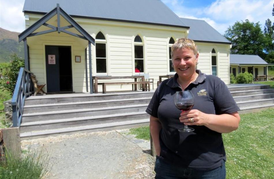 Waitiri Creek co-owner Paula Ramage, of Arrowtown, raises a glass of pinot noir to the second...