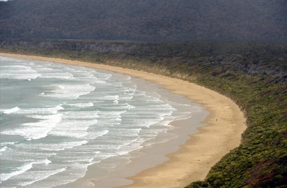 A person has the beach to themself at Tautuku Bay (below) on the Southern Scenic Route.